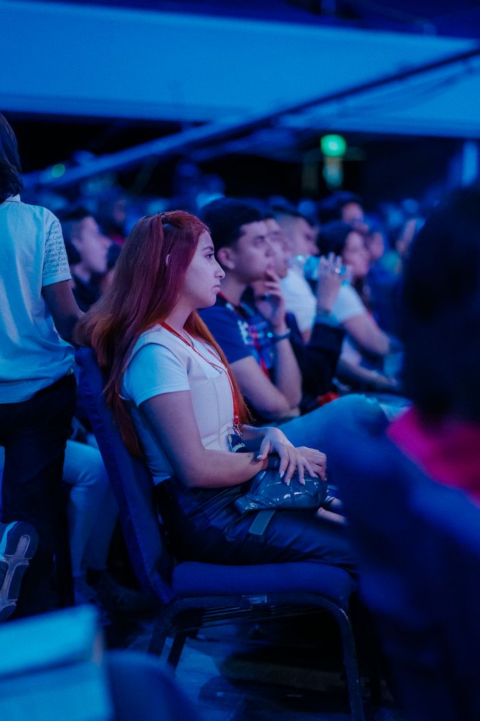 Crafting Captivating Headlines: Your awesome post title goes here A group of people attentively sitting indoors during an evening event.
